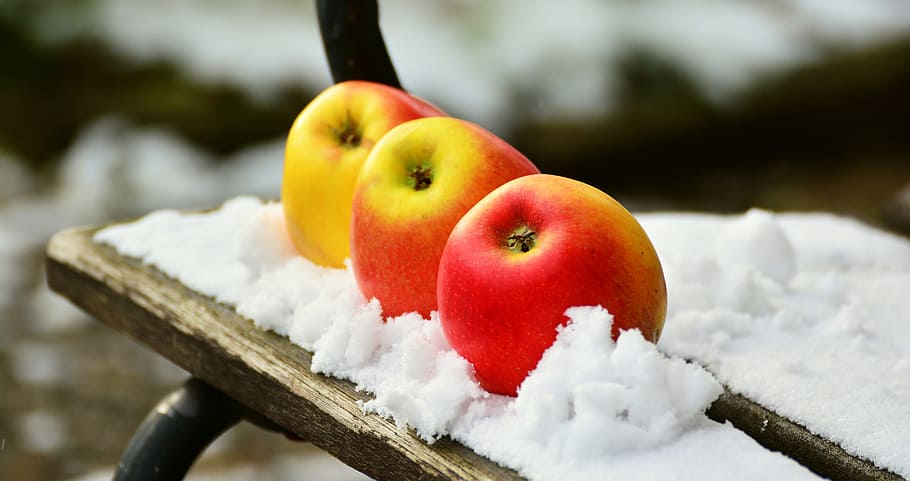 selective focus photography of three red apples on table covered with snow HD wallpaper