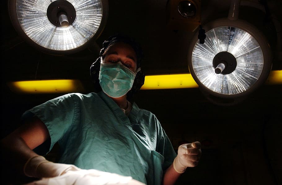 person wearing medical mask and teal scrub shirt, surgery, surgeon