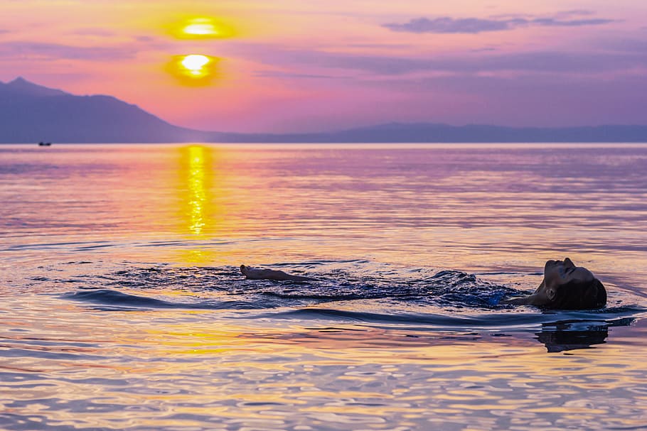 person floating on water by the setting of the sun, sky, sea HD wallpaper