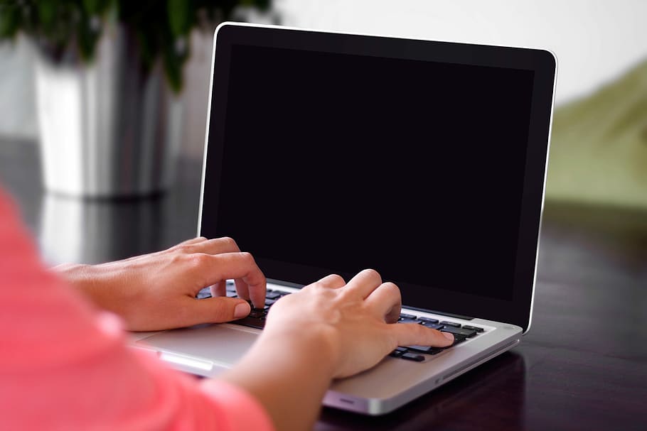 person wearing pink shirt typing on gray laptop computer on desk, person using gray laptop computer HD wallpaper