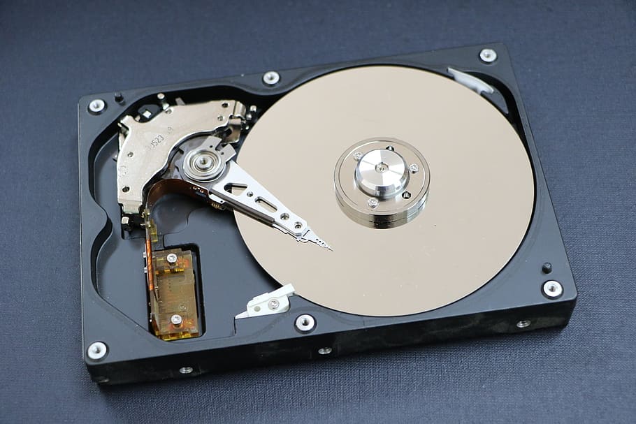 black and beige hard disk drive placed on gray surface, a hard disk drive HD wallpaper