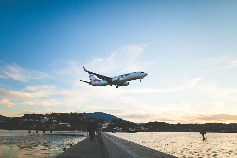 white and blue airplane flying during daytime, photo, concrete HD wallpaper