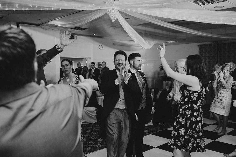black and white photo of group of people dancing, grayscale photo of group of people dancing inside room