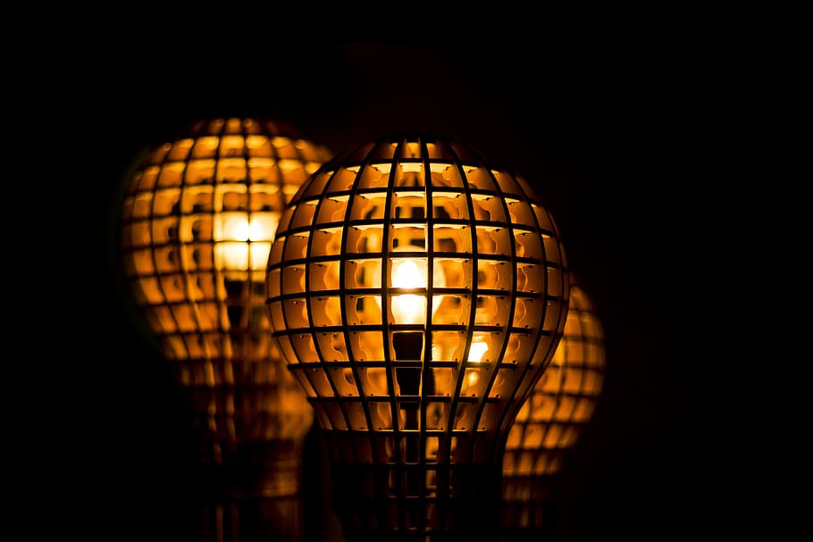 selective focus photography of lit lantern, three brown lamps on black surface HD wallpaper