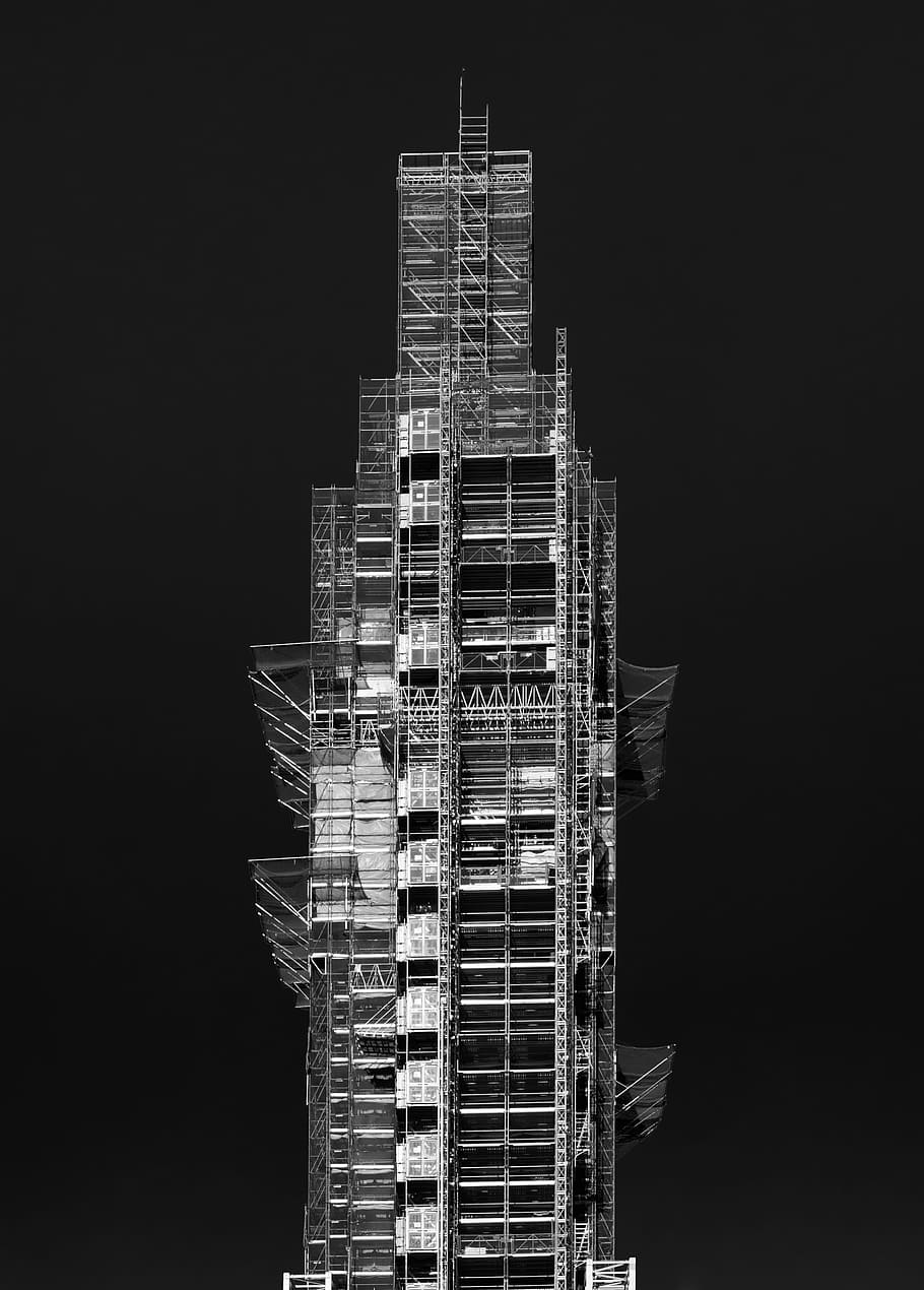 gray metal scaffolding, photography of gray concrete building under skies