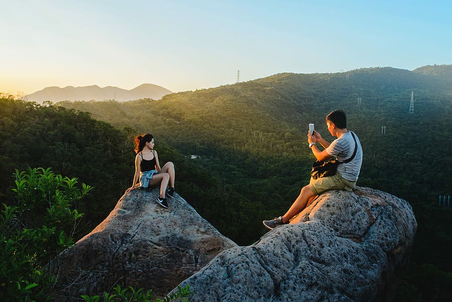 man taking photo of woman sitting on rack, mountain, adult HD wallpaper