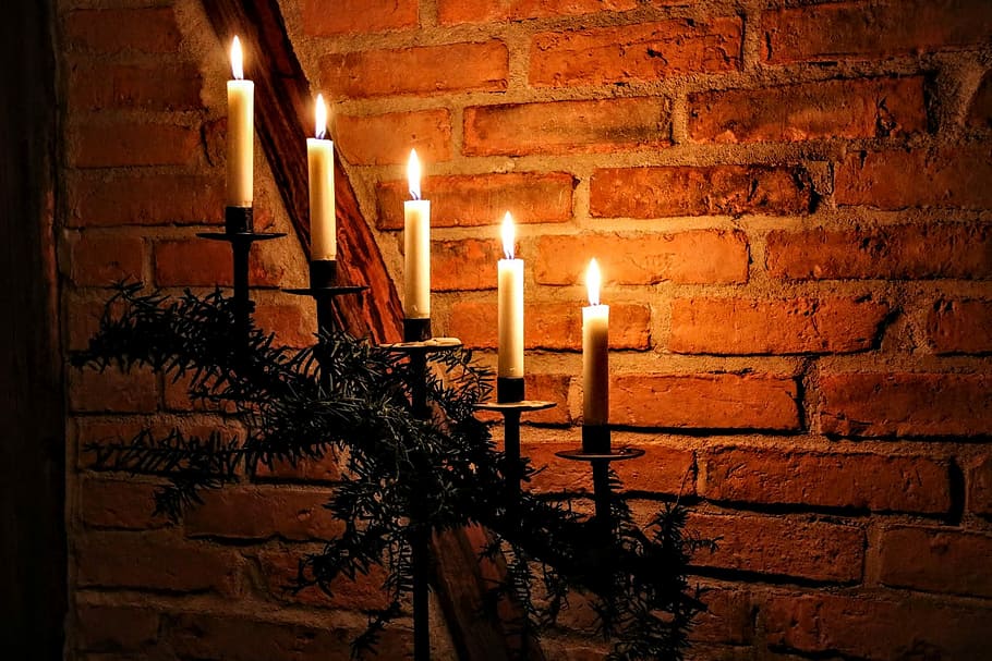 five lighted candles on candlesticks near brown brick wall, Christmas