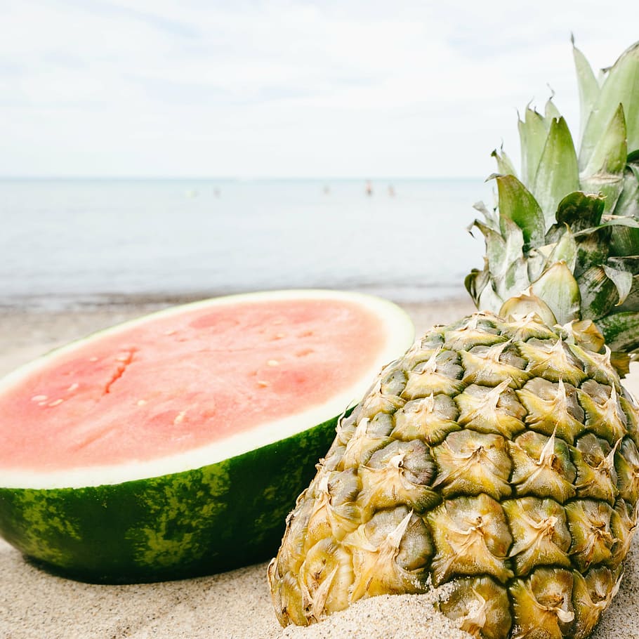yellow pineapple and sliced watermelon on brown sand, sunset HD wallpaper
