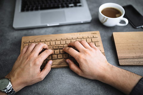 Young man typing on the wooden keyboard, workspace, workplace HD wallpaper