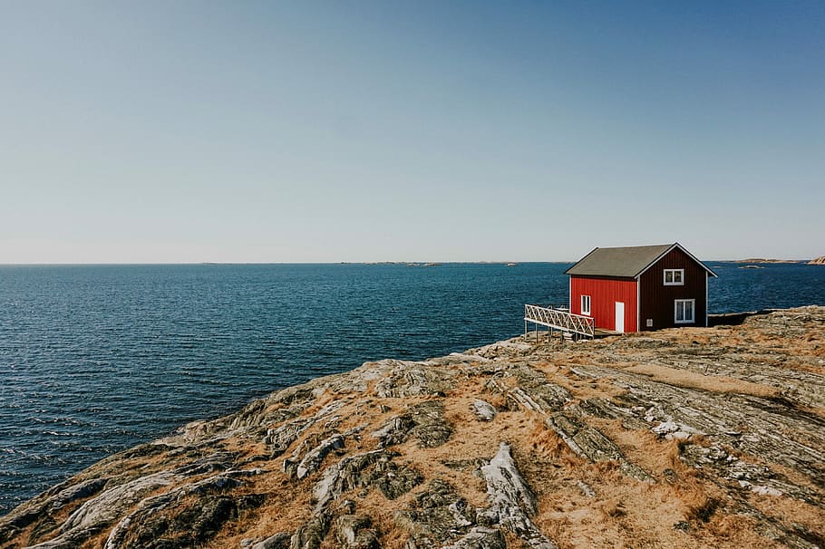 Island life, red house on cliff across the ocean, building, rock HD wallpaper
