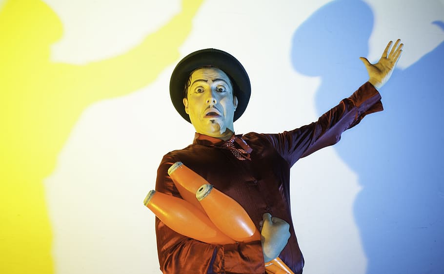 man holding three orange containers, Circus, Clowns, Show, helmet HD wallpaper