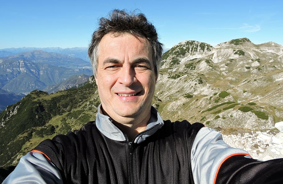 man taking selfie on top of mountain, small dolomites, alps HD wallpaper