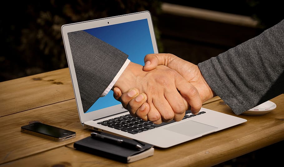 shaking hands near gray laptop computer, handshake, monitor, online