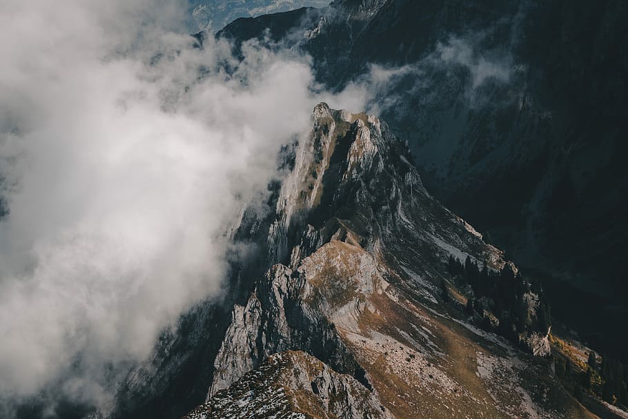 bird's eye view photograph of mountain, brown and gray mountain under white clouds HD wallpaper