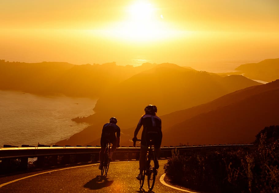 two persons biking during dawn, bikers, riding, sunset, mountain, HD wallpaper