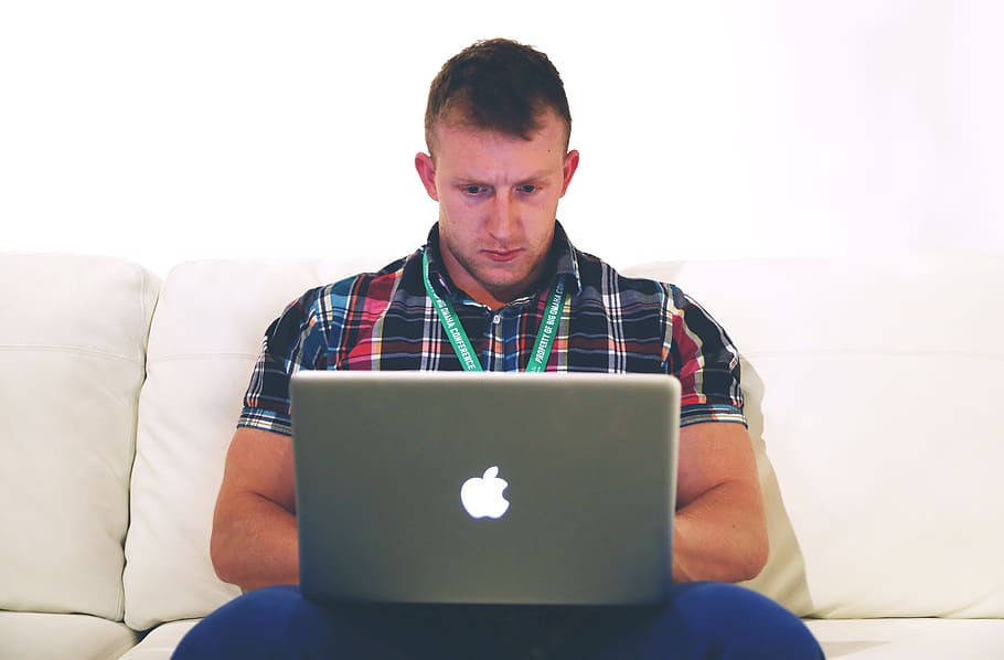 man using gray macBook on sofa, lancer, typing, notebook, laptop HD wallpaper
