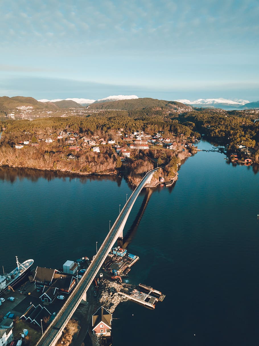 bird's eye view photography of bridge connecting island, aerial photography of black and white concrete bridge HD wallpaper