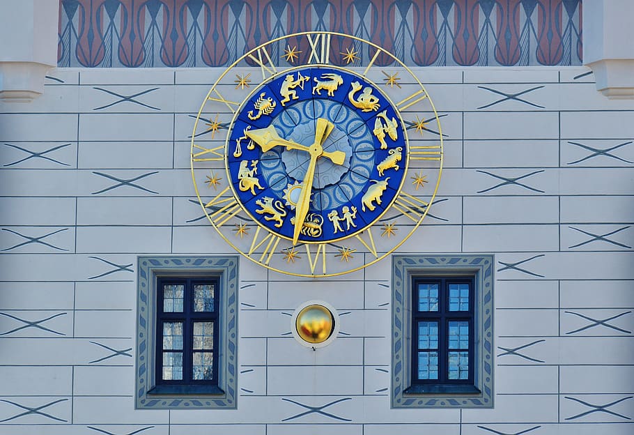 round gold framed analog wall clock at 9:32, clock tower, toy museum