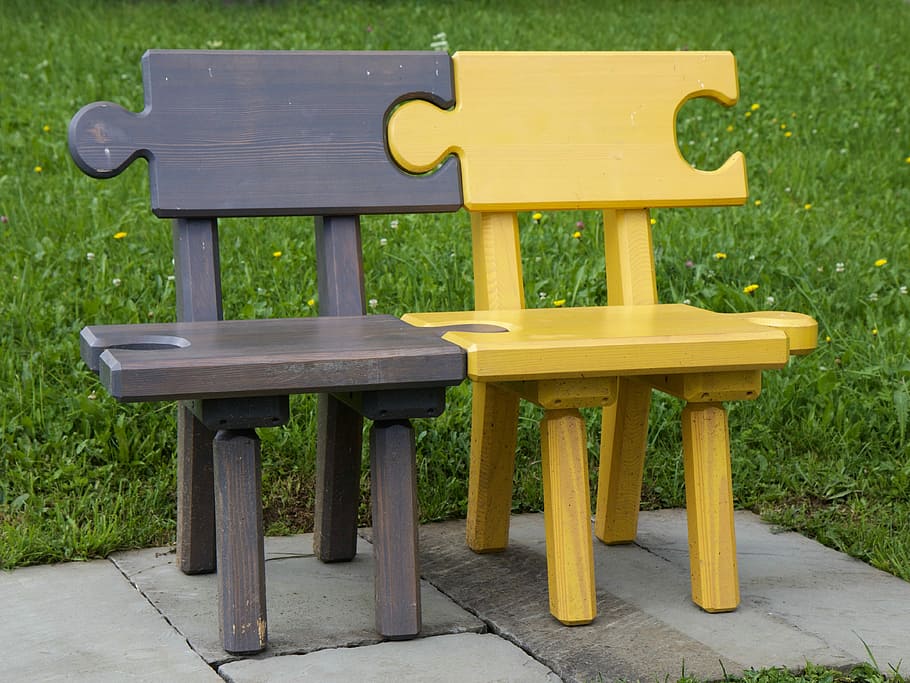 brown and yellow puzzle bench on concrete ground surrounded green grass field during daytime HD wallpaper