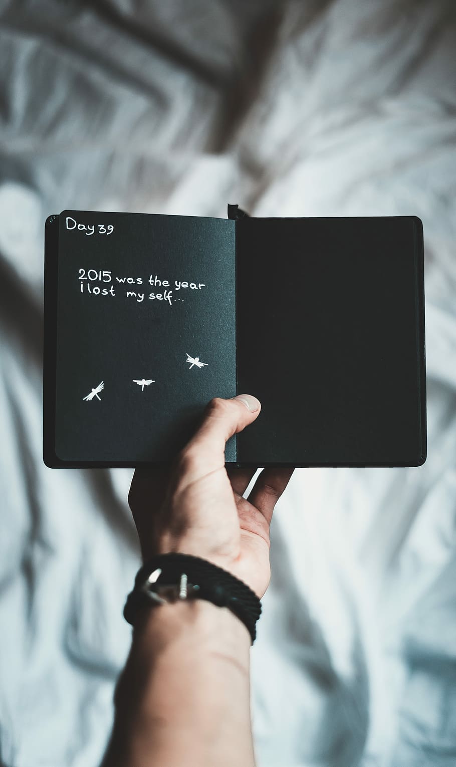 person holding black notebook, black Day 39 2015 printed book HD wallpaper