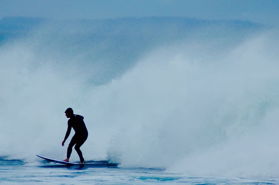 man riding surfboard near wave, silhouette of man surfing in body of water HD wallpaper