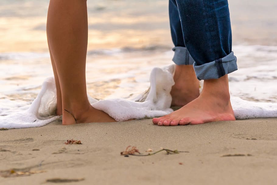two person standing on the sand, beach, barefoot, seashore, water