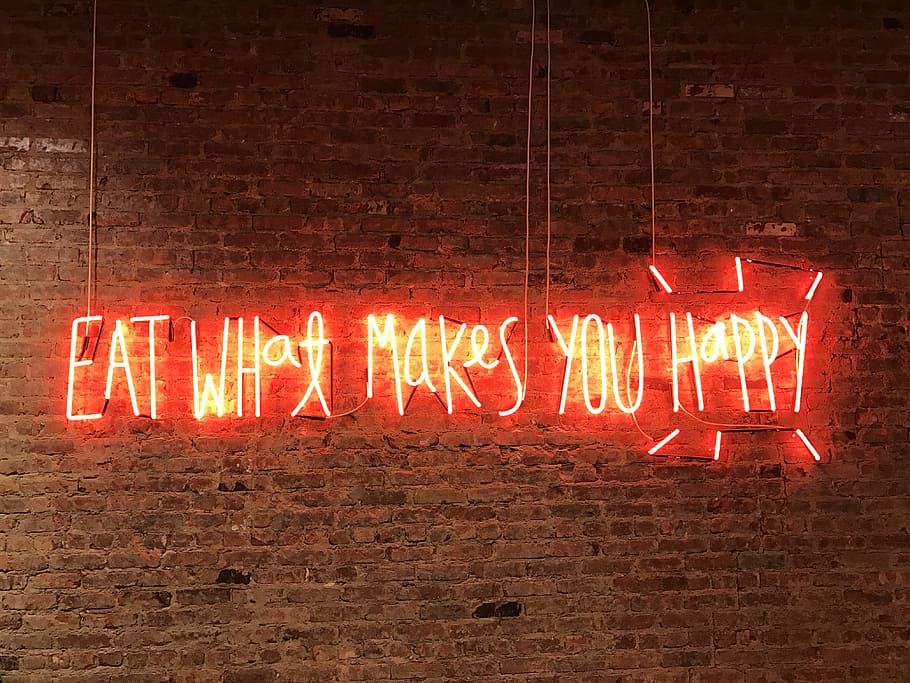 lighted eat what makes you happy neon signage, brown brick wall with quotes text overlay, HD wallpaper