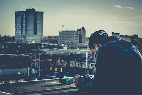 man wearing blue denim jacket looking at grey city, black, cap HD wallpaper