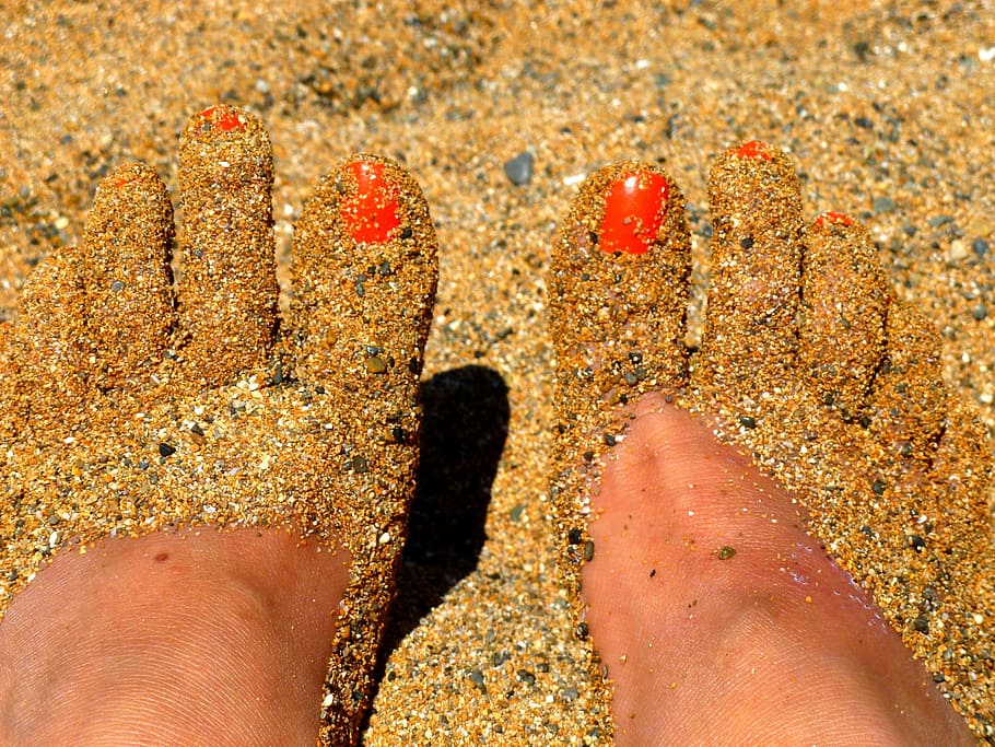 human feet covered with sand, part of the body, beach, barefoot