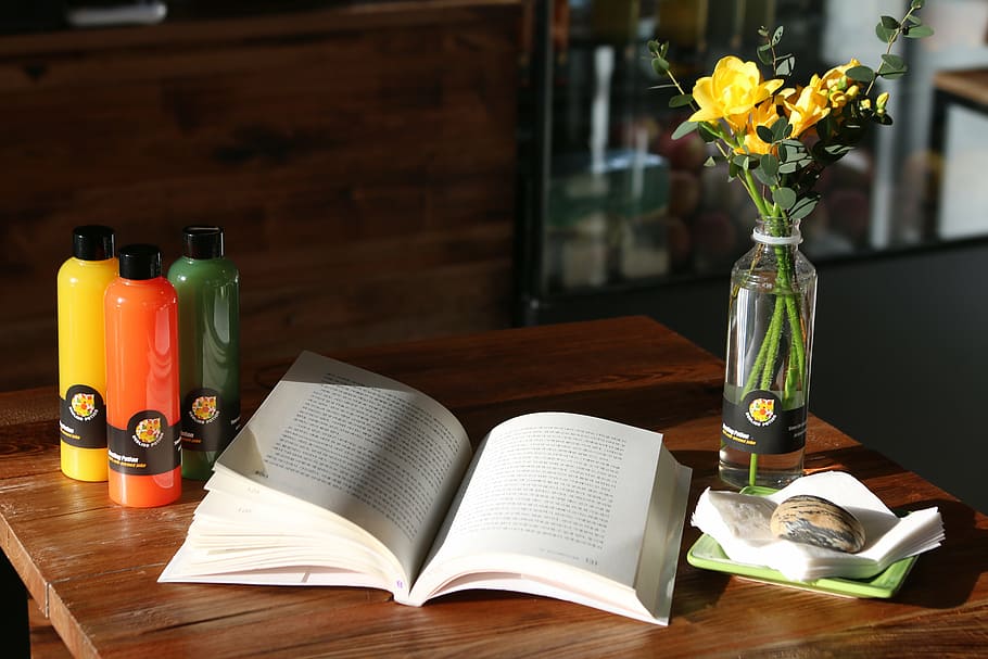 open book on top of table beside flower vase with yellow roses HD wallpaper