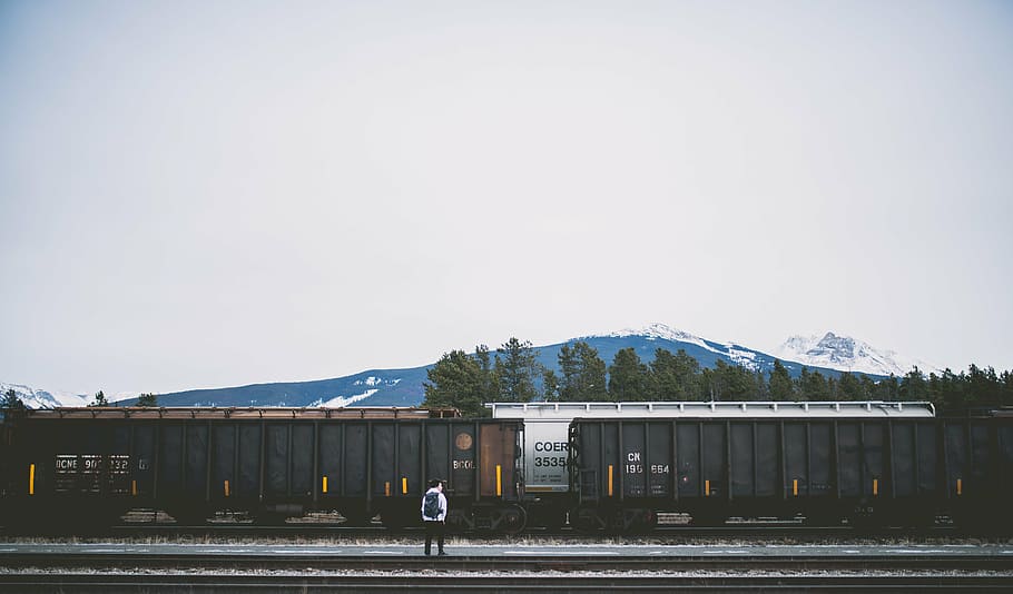 man standing in front of black train, railway, track, transportation HD wallpaper