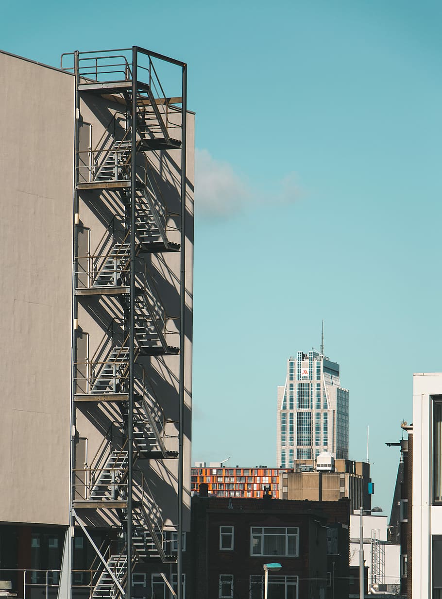 The city of Rotterdam, brown concrete building at daytime, sunlight HD wallpaper
