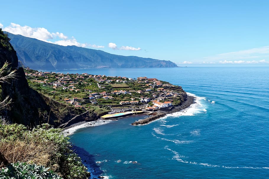 aerial photo of village near body of water beside mountain, madeira