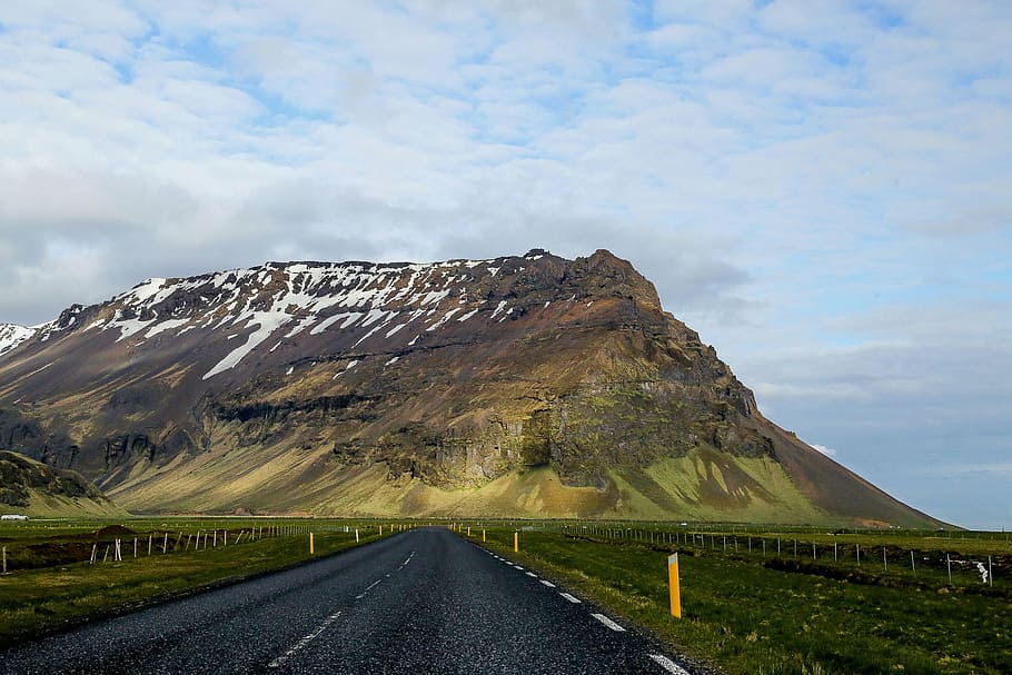 brown and green hills during daytime, empty road along mountain HD wallpaper