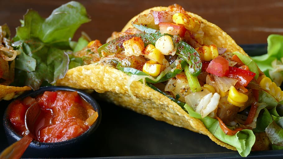 taco with vegetables and corn with sauce, tomato, corn kernels