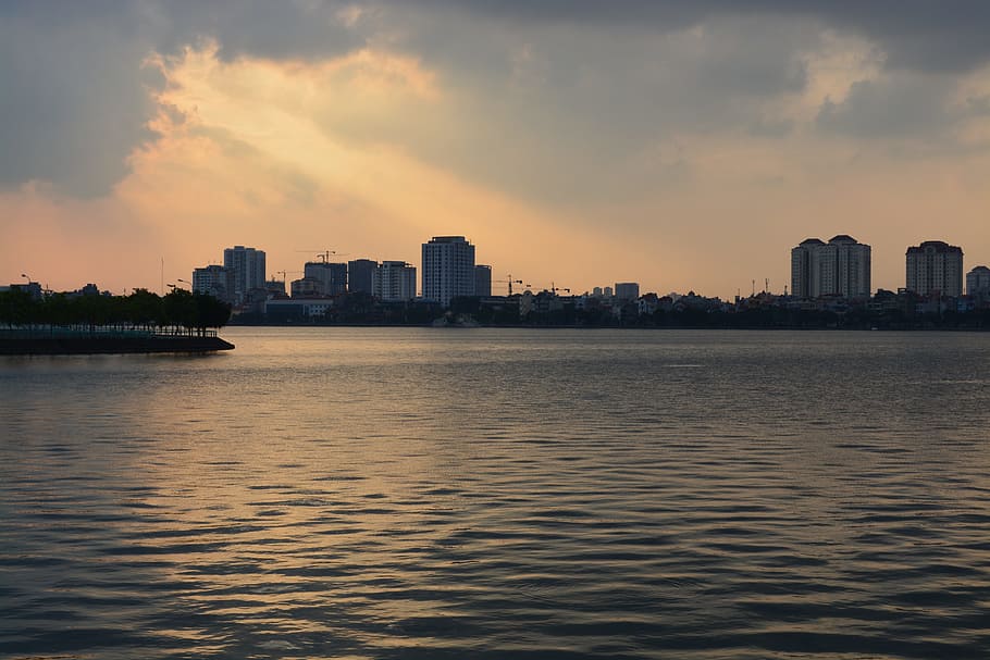 calm body of water, hanoi, sunset, lake, city scape, sky, architecture