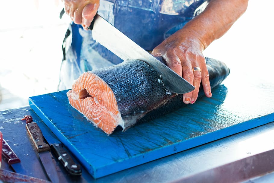 Cutting fresh caught salmon, cooking, fish, hands, market, process