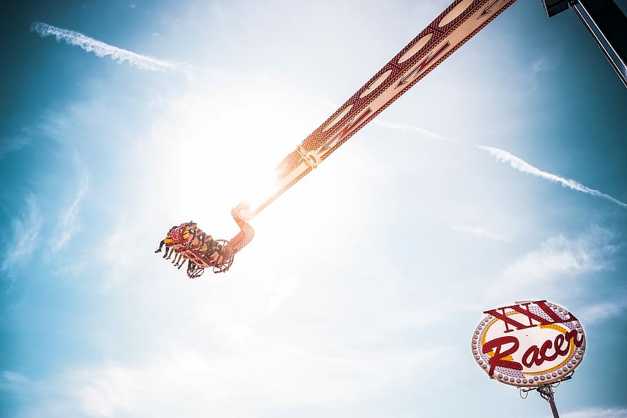 people riding XXL racer rides, extreme ride over XXL racer signage HD wallpaper