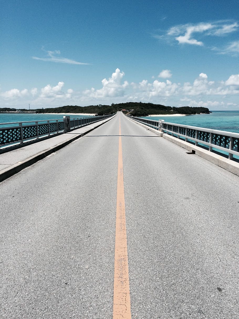 asphalt road near mountain under blue and white cloudy sky, bridge during daytime HD wallpaper