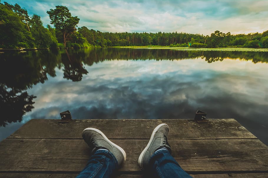 Man with his feet in shot relaxing at a lake, people, adventure