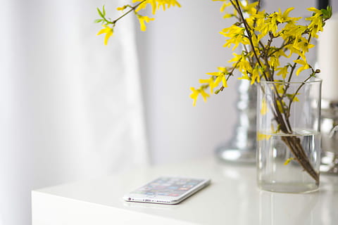White smartphone with yellow flowers, notebook, mobile phone HD wallpaper
