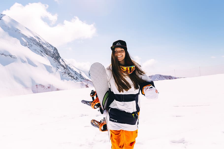 woman holding snowboards during winter season, sports, extreme