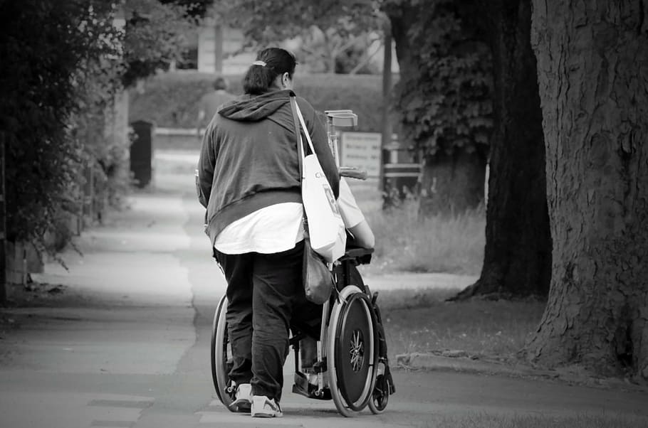 grayscale photography of woman pushing wheelchair, help, women