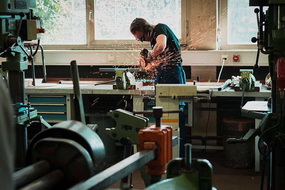 selective focus photography of man using angle grinder, man holding circular saw HD wallpaper