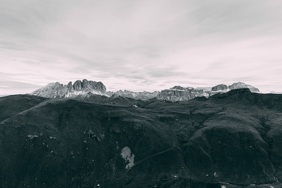 black covered mountain under white sky, aerial photo of brown hills HD wallpaper