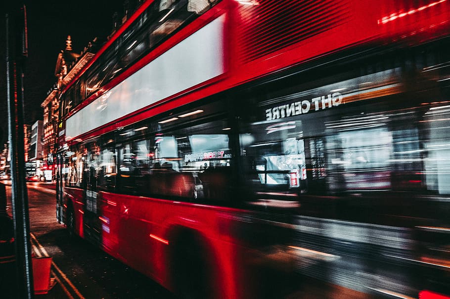 time lapse of red bus, timelapse photography of red double decker bus passing between buildings HD wallpaper
