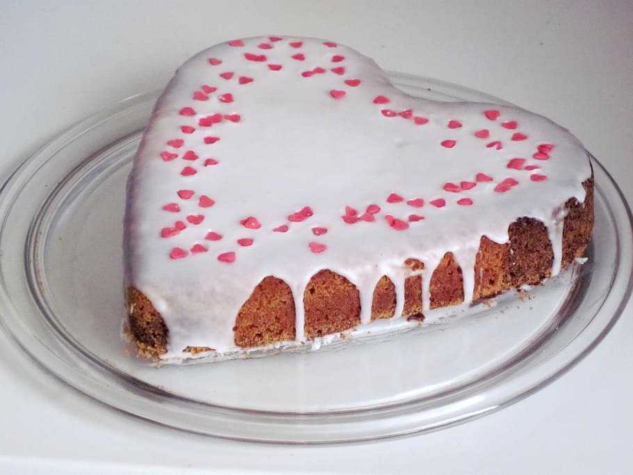 heart-shaped milk coated cake on top of clear glass plate, love cake