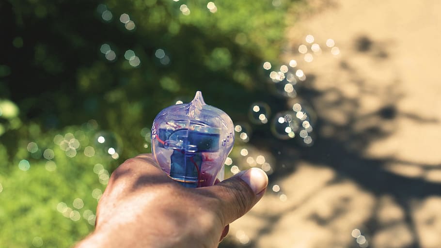 Person Holding White and Blue Plastic Bubble Dispensing Gun, bubble gun HD wallpaper