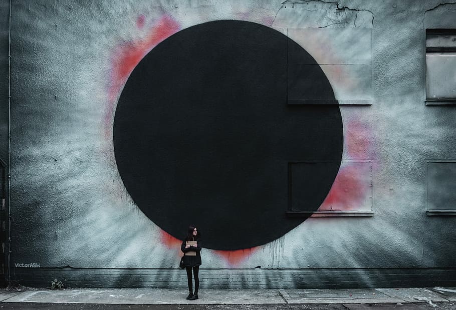 person standing near the wall illustration, woman standing near wall with solar eclipse painting HD wallpaper