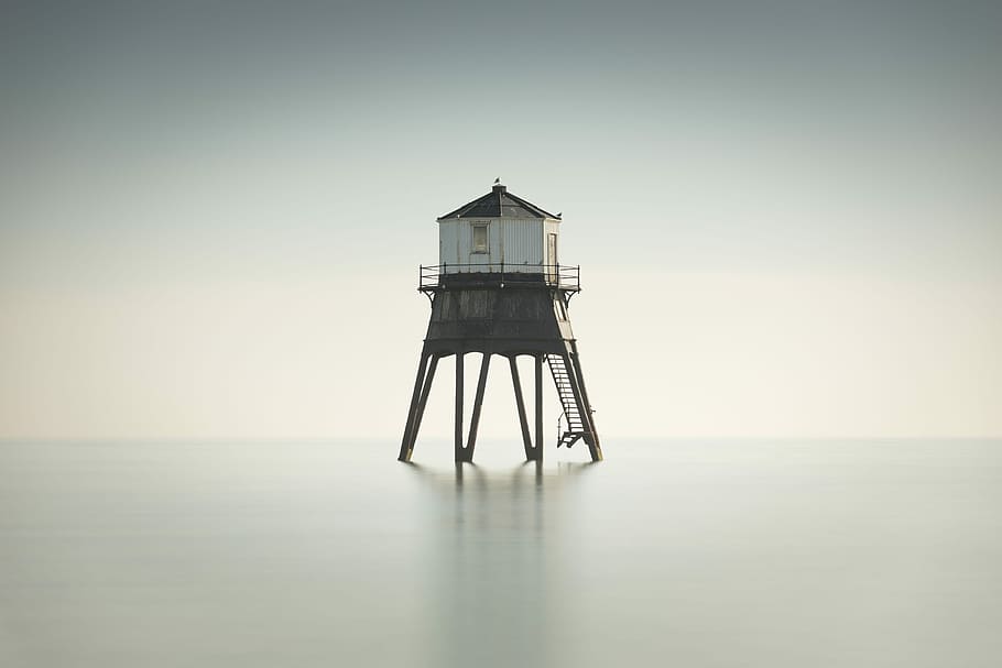 Sentinel, lighthouse between on body of water, sea, building HD wallpaper
